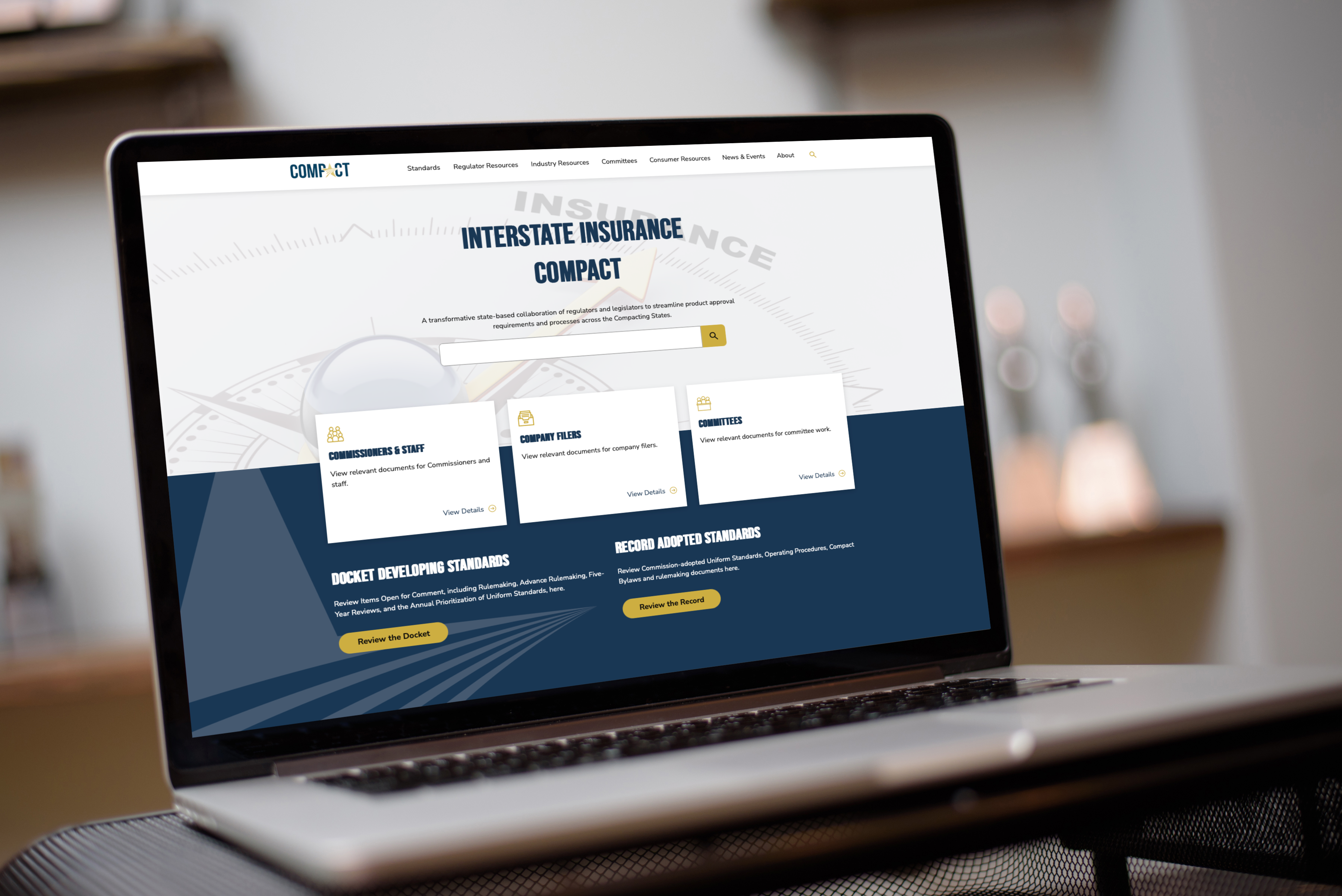 The Insurance Compact website on a laptop
