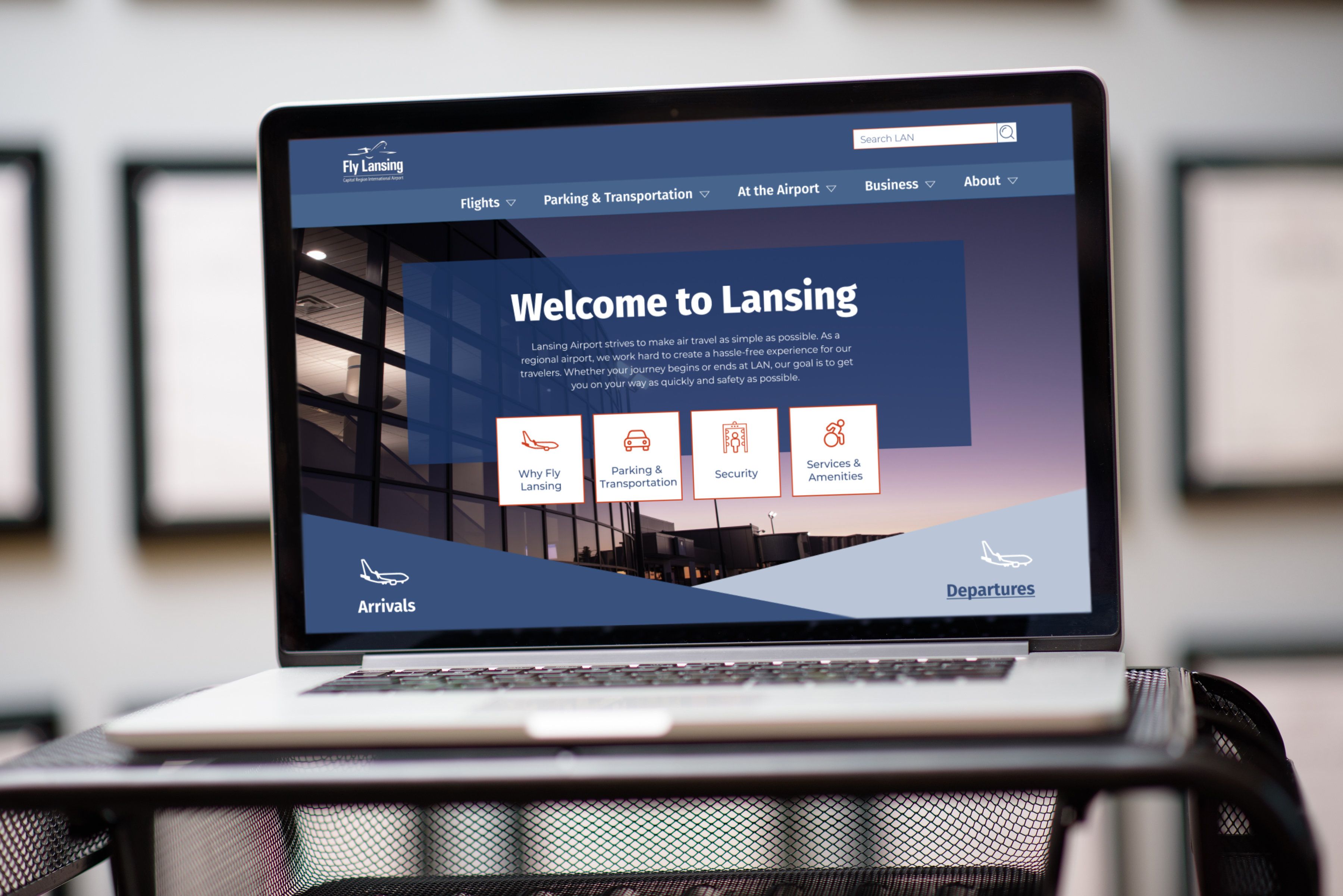 The Lansing Airport website on a laptop