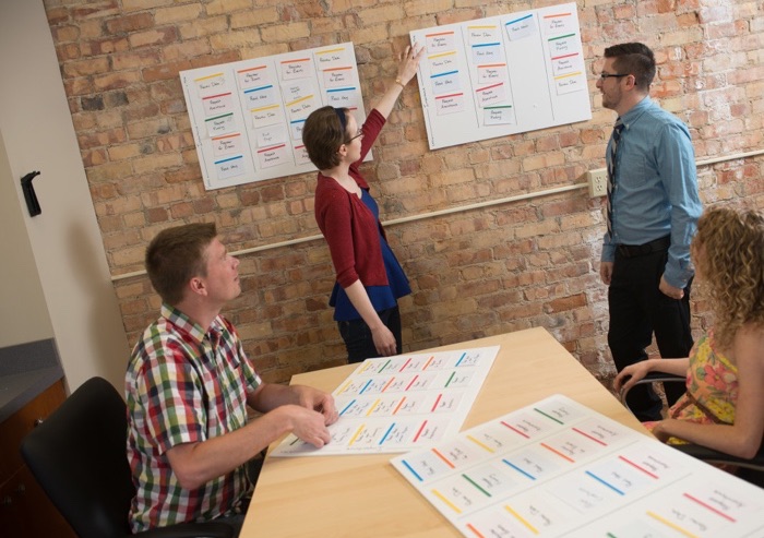 A group of people reviewing sets of note cards