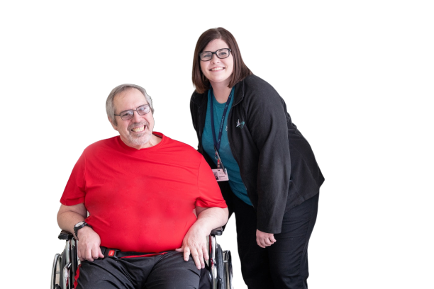 An Origami client, seated in a wheelchair, next to an Origami team member